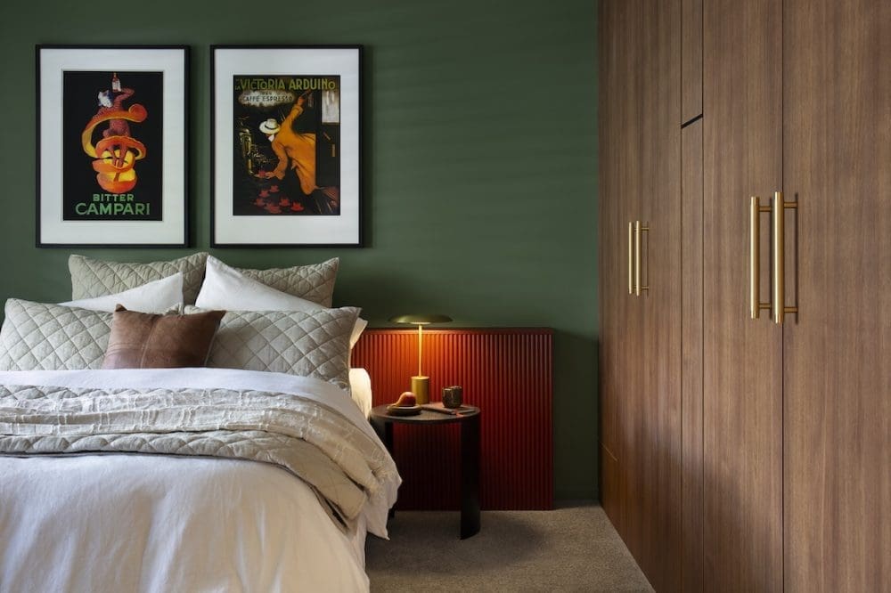 Green bedroom with timber cabinetry in Warm Embrace residence by The Stylesmiths