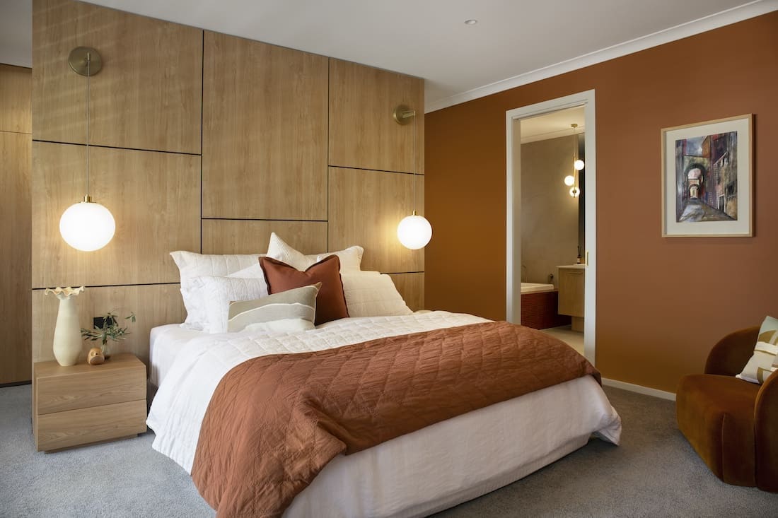 Orange bedroom wall in Warm Embrace residence by The Stylesmiths