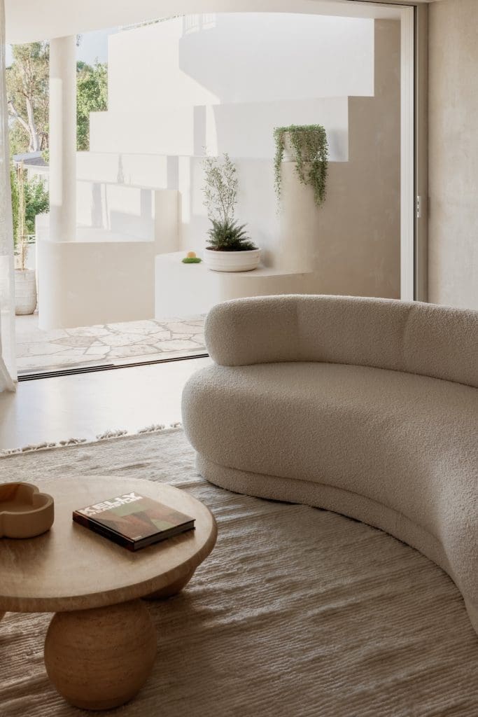 Curved neutral sofa with view to outdoor living