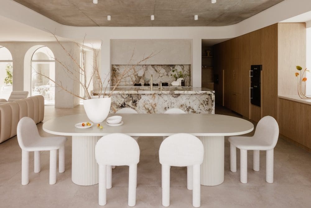 Dining and kitchen with heavily veined marble benchtop at Gréce
