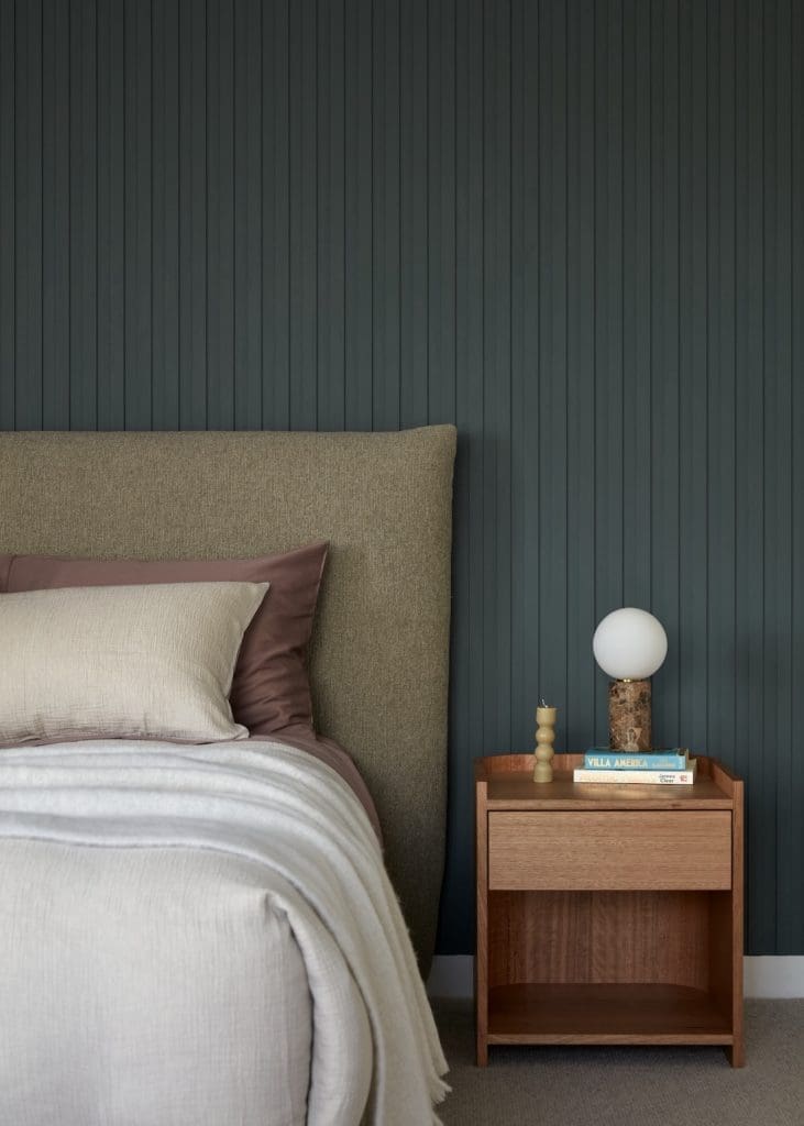 Dark feature wall in moody bedroom