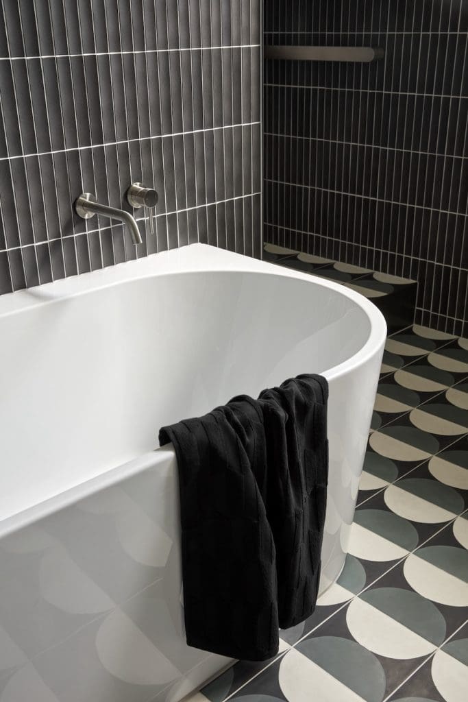 Curved bath with patterned floor tiles