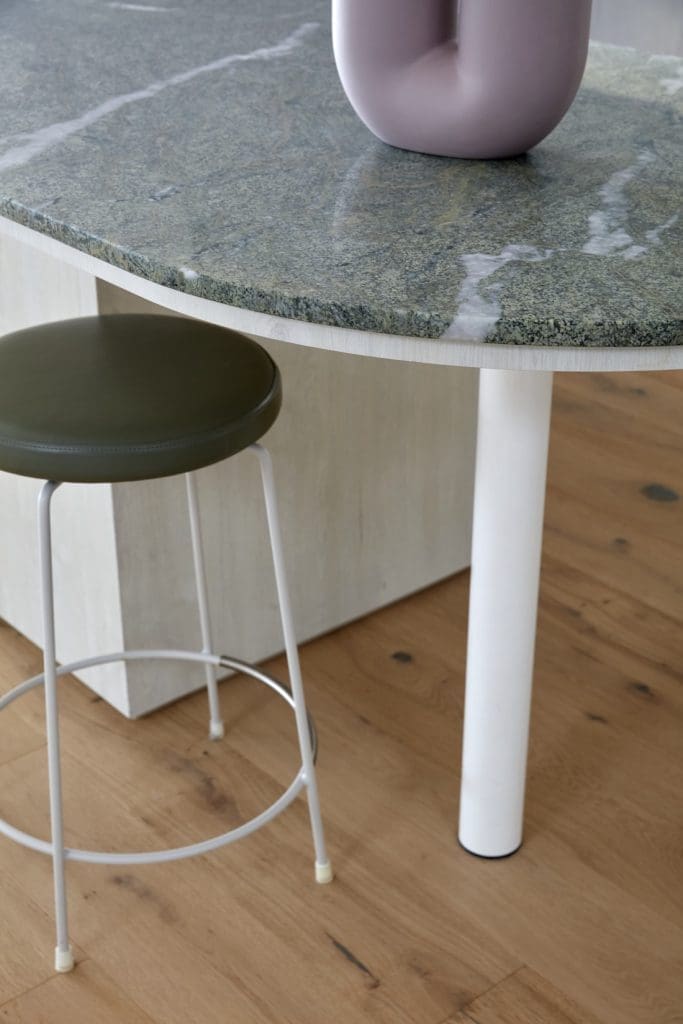 Green stone kitchen island with white legs