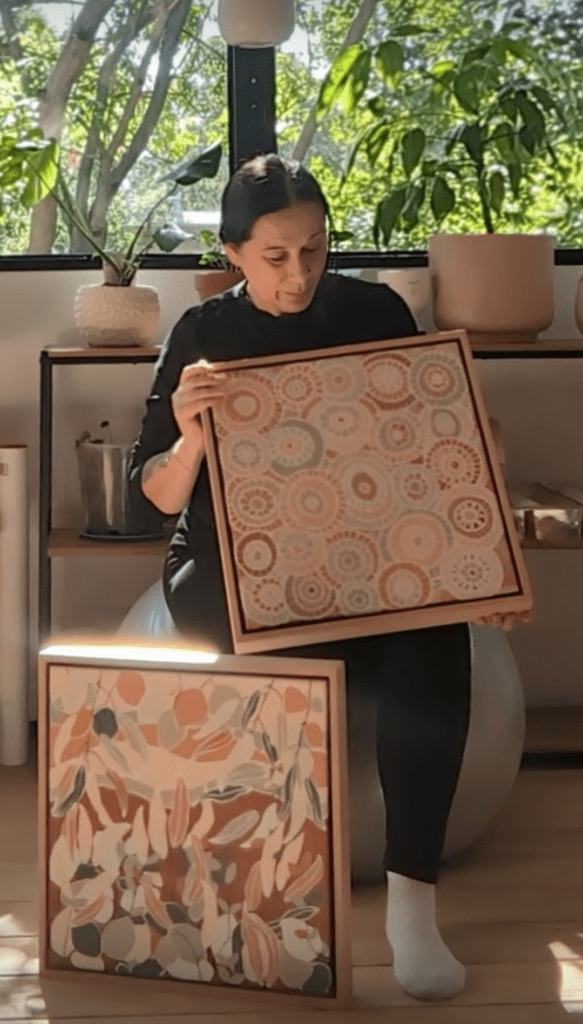 Karen Lee Mungarrja showcasing some original artwork
