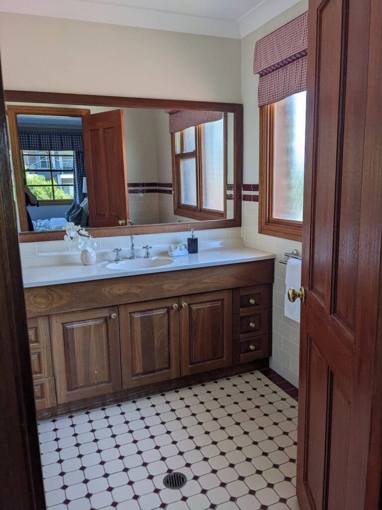 North Ryde before the makeover - 2000s dark timber and dated tile bathroom