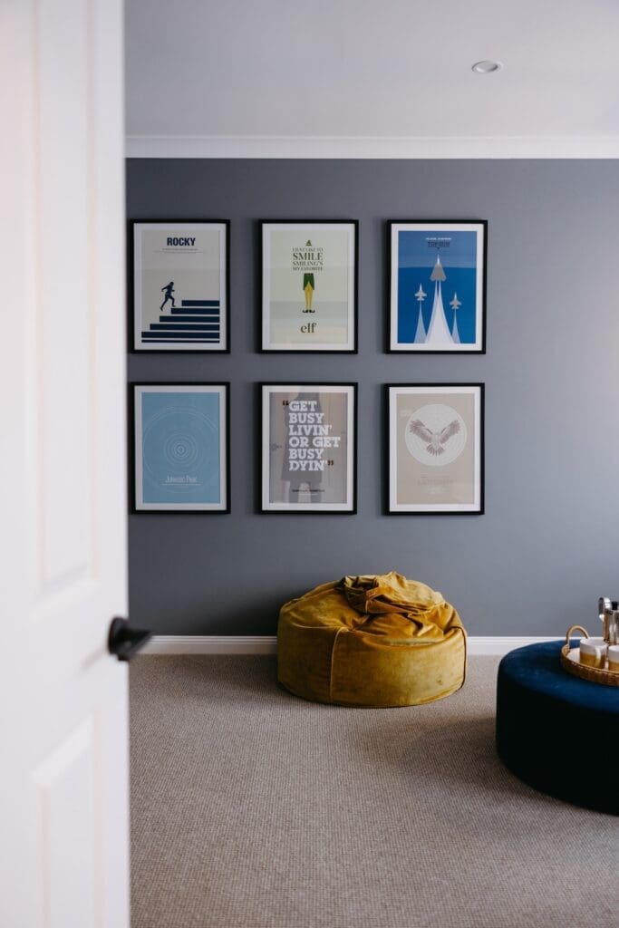 Yellow velvet bean bag with movie poster gallery wall