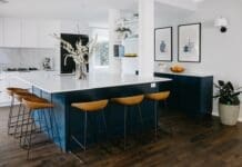 Hamptons style kitchen with blue kitchen island bench