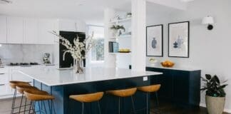 Hamptons style kitchen with blue kitchen island bench