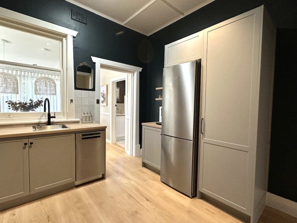 Kitchen pantry and fridge in Alisa and Lysandra coastal heritage Tudor AirBnB