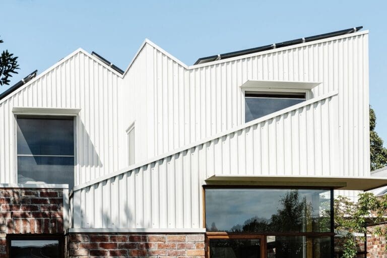 White and red brick exterior of Chatterbox House