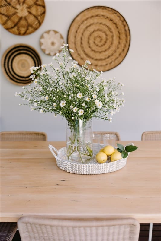 Daises and lemons styled on outdoor dining table