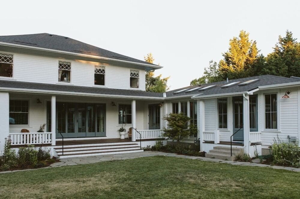 Farmhouse exterior with pops of colour on doors