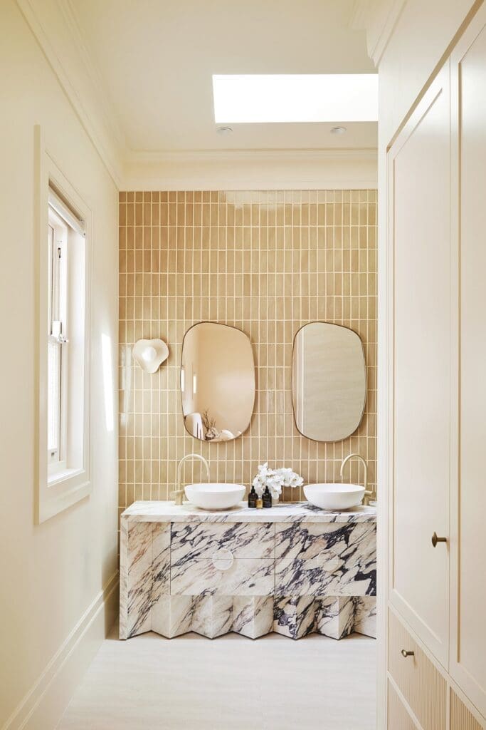 Luxe bathroom ensuite with marble vanity and double organic mirror