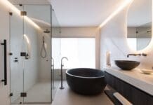 Black and white bathroom with round black bath