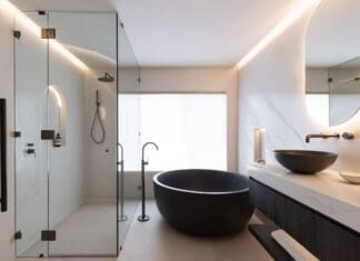 Black and white bathroom with round black bath