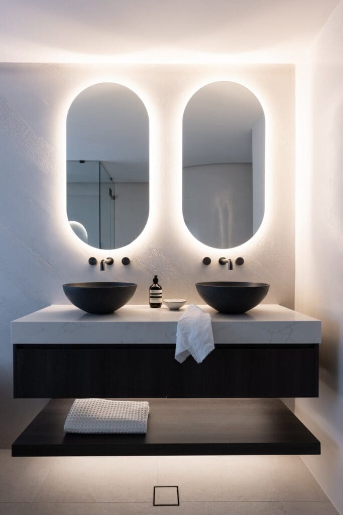 Double pill shaped back lit mirror