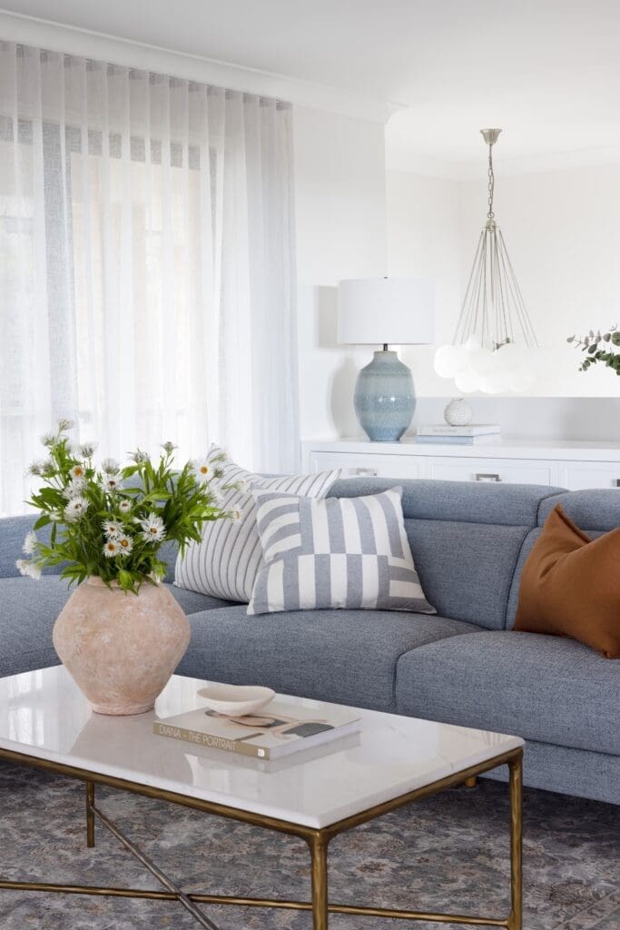 Blue couch in living room with Hamptons styling
