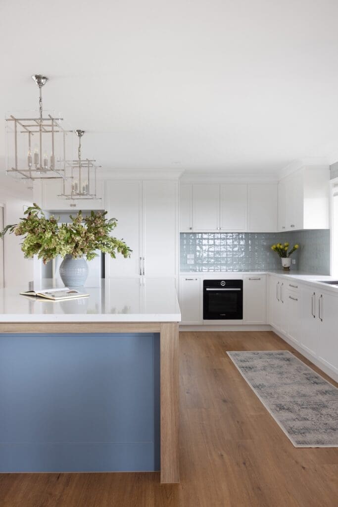 Country style kitchen with Hamptons lights and blue island bench