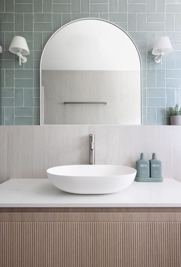 Blue bathroom with arch mirror