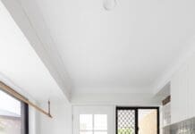 Country farmhouse laundry with green accents and a floor runner