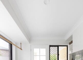 Country farmhouse laundry with green accents and a floor runner