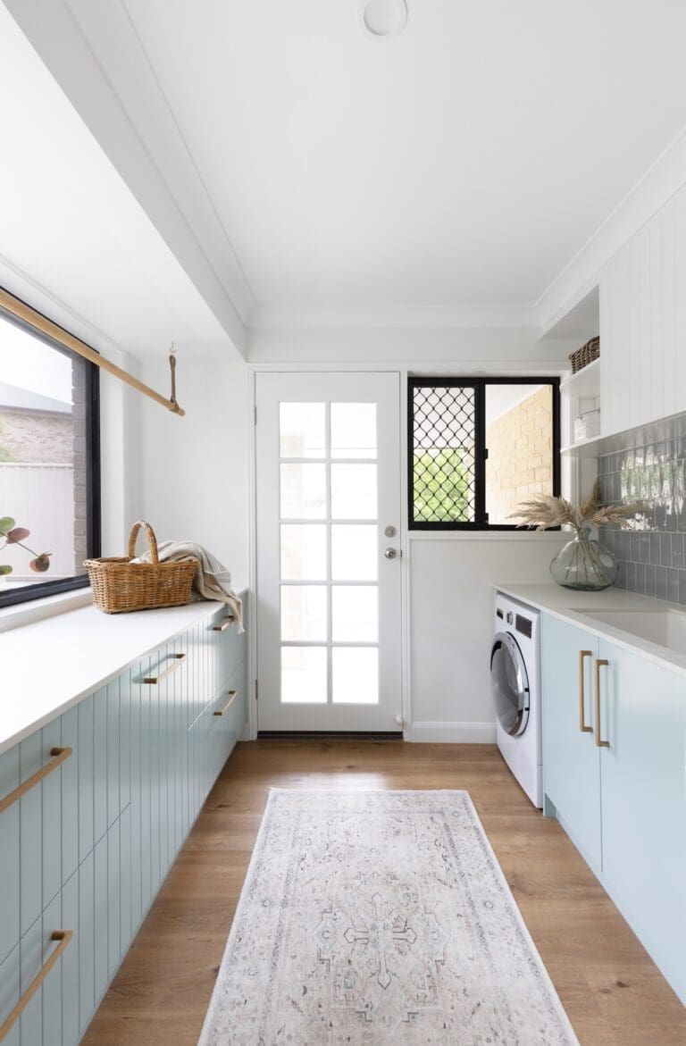 Country farmhouse laundry with green accents and a floor runner