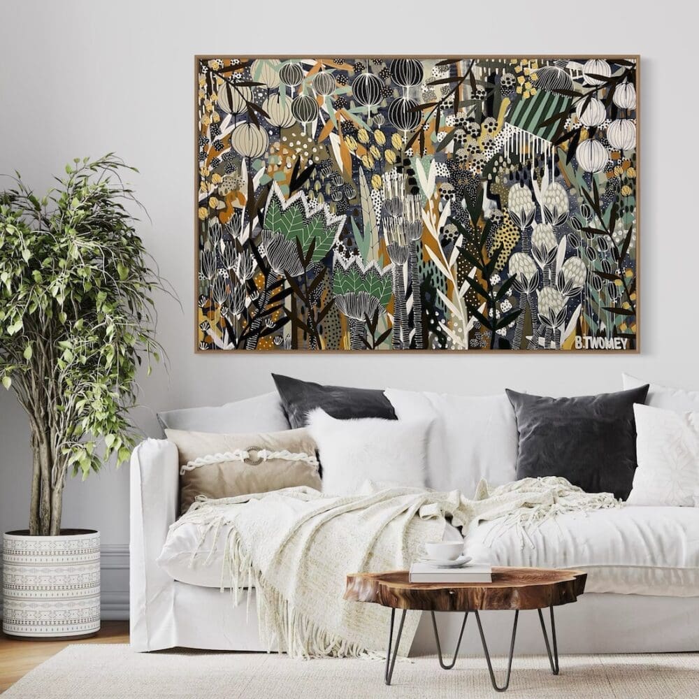 Colourful botanical artwork from B Twomey above a couch in living room