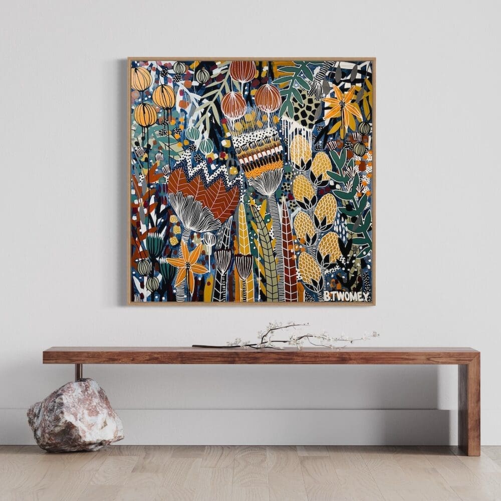 Colourful botanical artwork from B Twomey above a timber bench