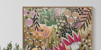 Colourful botanical artwork from B Twomey above a sideboard