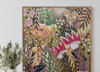 Colourful botanical artwork from B Twomey above a sideboard