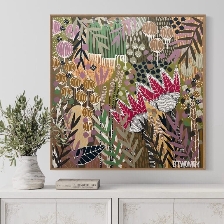 Colourful botanical artwork from B Twomey above a sideboard