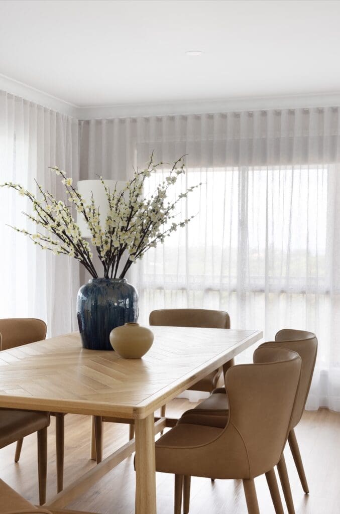 Dining table with large floral arrangement in centre