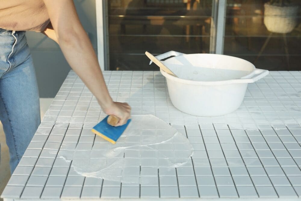 Spread grout using a float