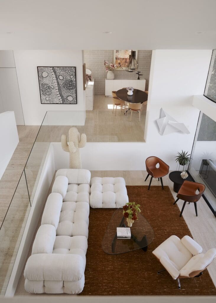 Plush modular sofa and quirky cactus sculpture in mid-century modern living room