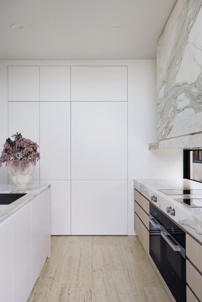 Integrated appliances in luxury marble kitchen
