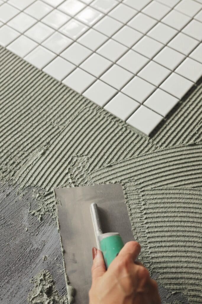 Use notched trowel to spread tile glue