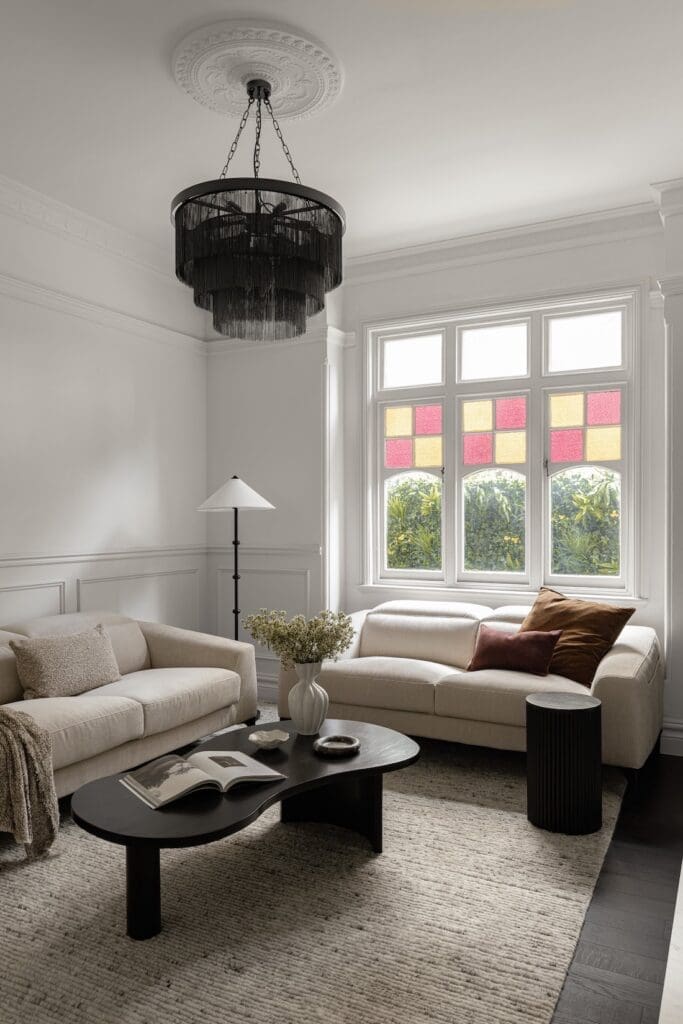 Living room with leadlight windows in modern heritage home from Branche Designs