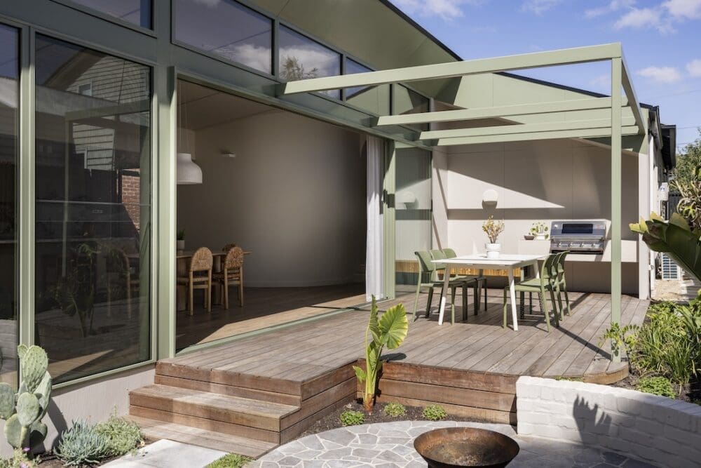 Green exterior of home using brushed concrete from Build Her Collective