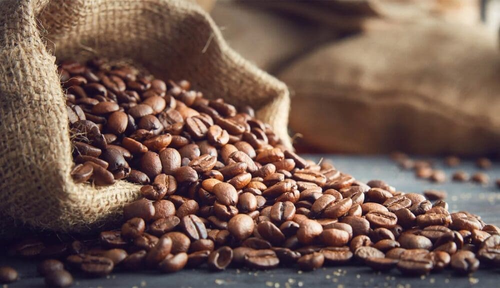 Coffee beans spilling out of canvas bag