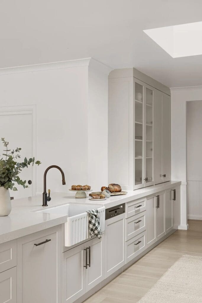 White kitchen with farmhouse sink at Ewingsdale home