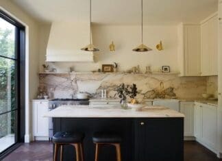 New traditional kitchen renovation bathed in luxe marble Marble kitchen renovation with black island