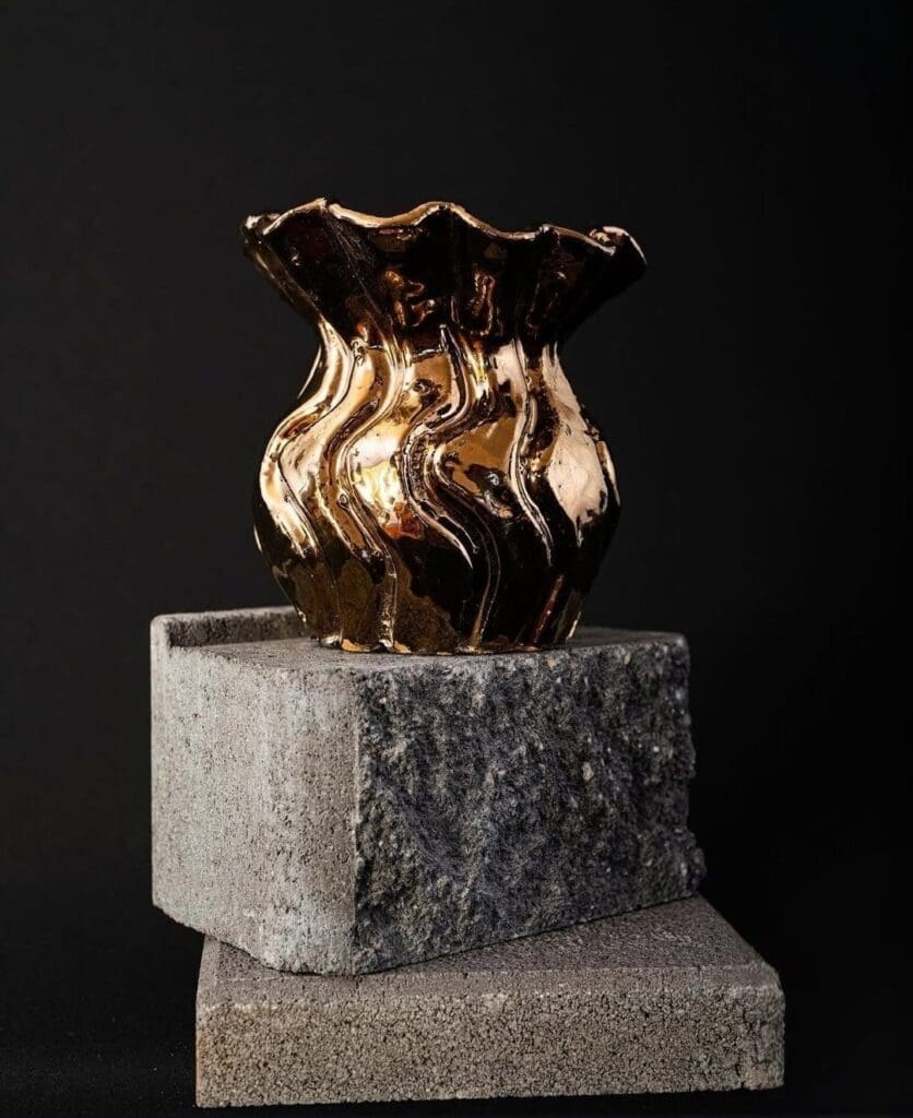 Gold vase called Getting Out of Bed by Elena Strohfeldt