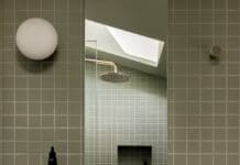 Green grid bathroom: A serene space inspired by Japanese design White pedestal basin in green grid tile bathroom