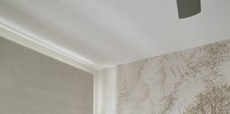 White side table and feeding chair in nursery