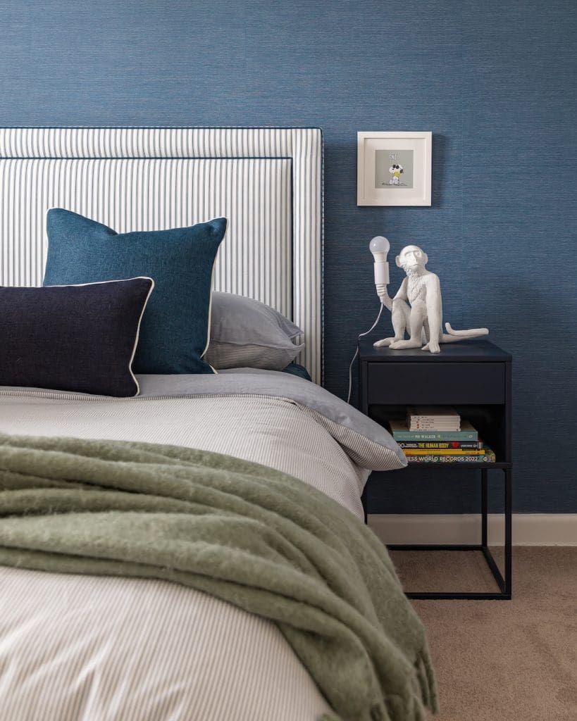 Blue bedroom with monkey lamp at Patterned Sanctuary by The Stylesmiths