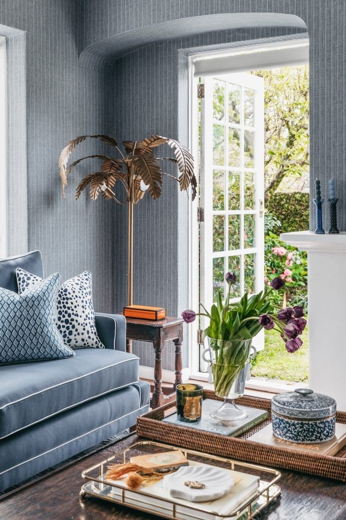 Palm tree floor lamp by exterior door in living room at Patterned Sanctuary by The Stylesmiths