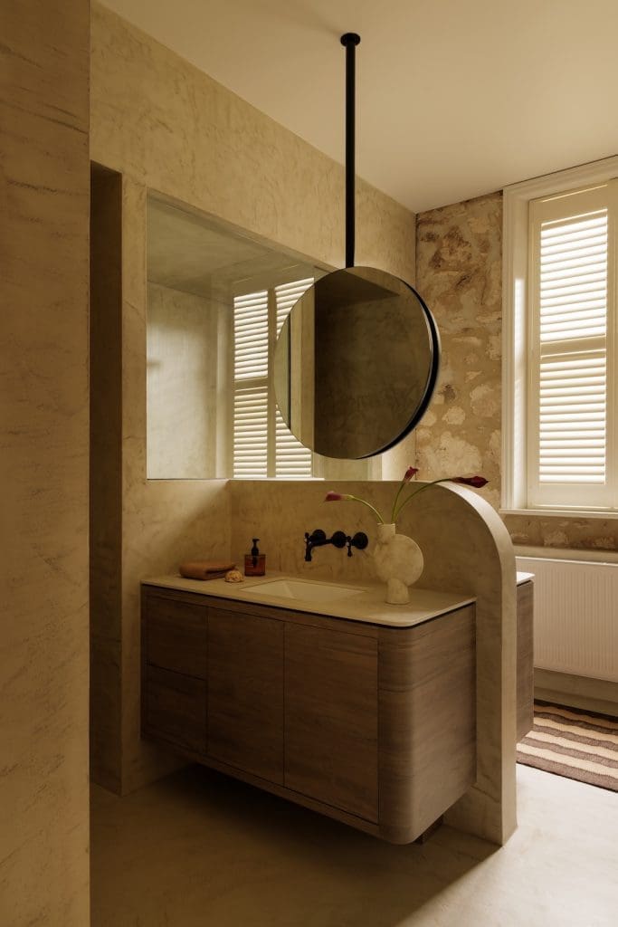 Bathroom with floating mirror at Coastal Alchemy by The Stylesmiths