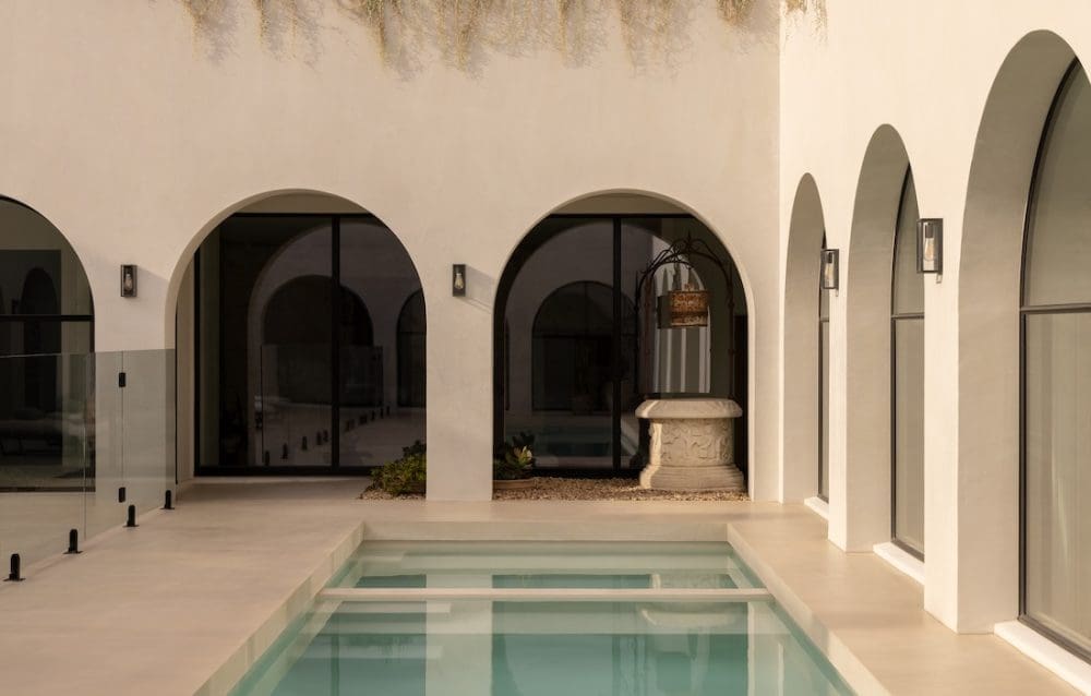 Pool with archways around outside at Coastal Alchemy by The Stylesmiths
