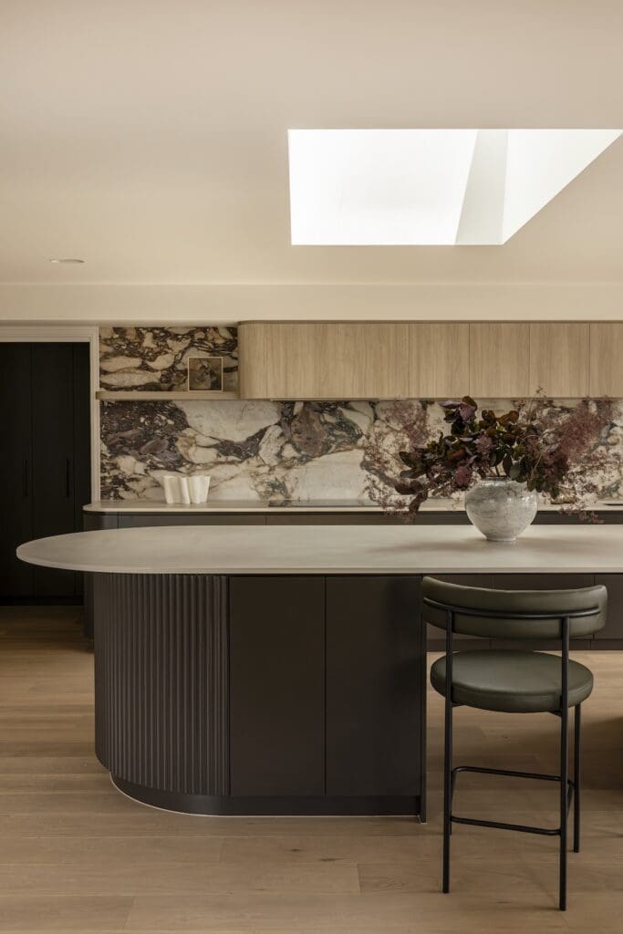 Kitchen with curved island bench and skylight in Deakin Home