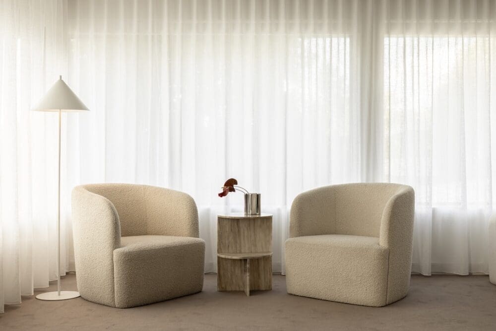 Seating area with sheer curtains in Deakin Home